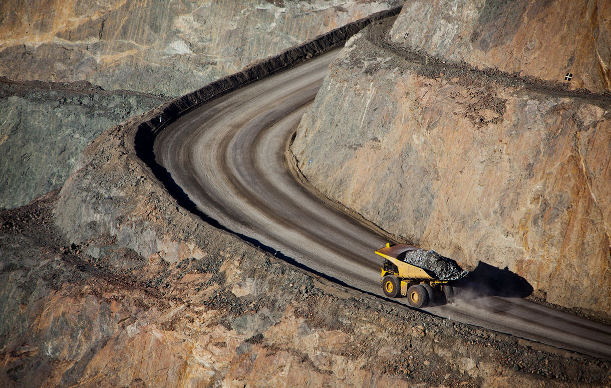 mining vehicle traveling through open pit mine